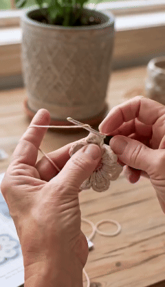 Hands crocheting one of the decorative motifs