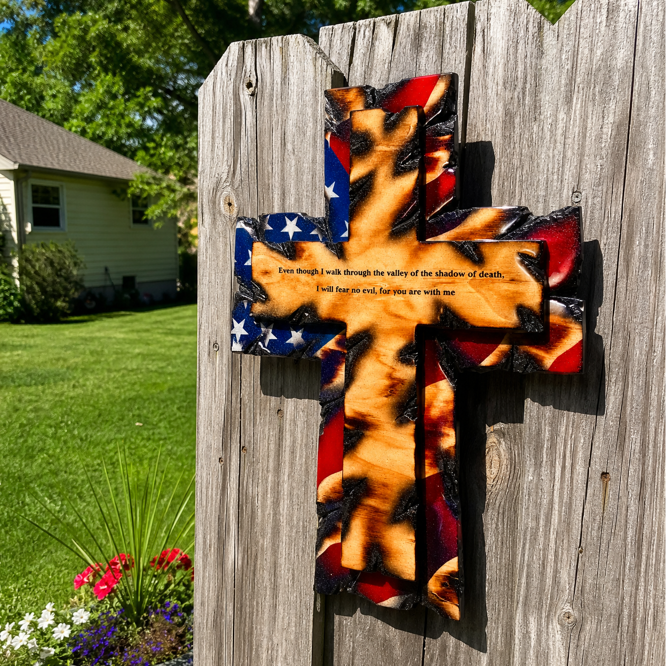 Tattered Flag Cross hung on a backyard wood fence in the sun